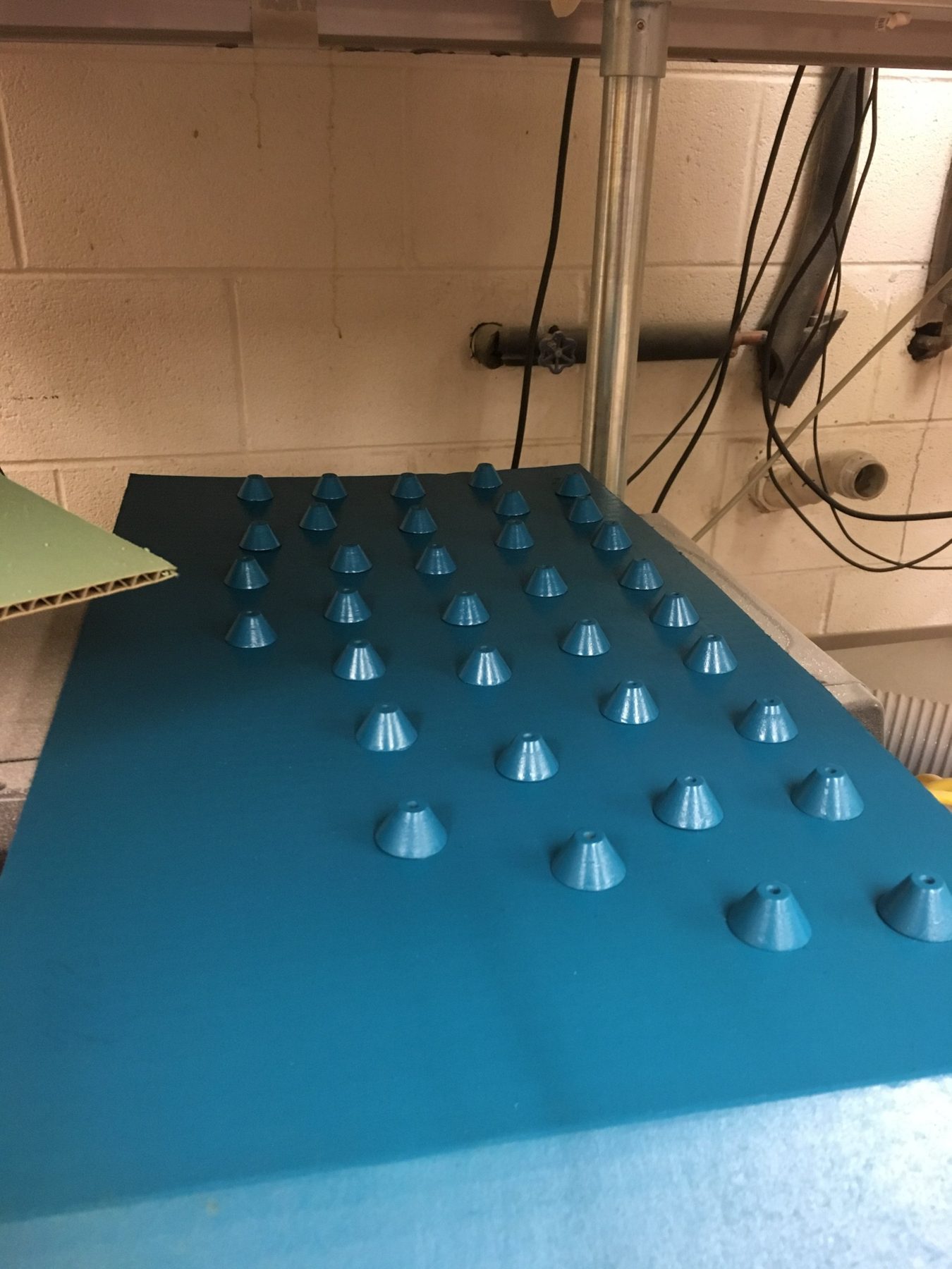Rows of spacers spray painted blue on a board