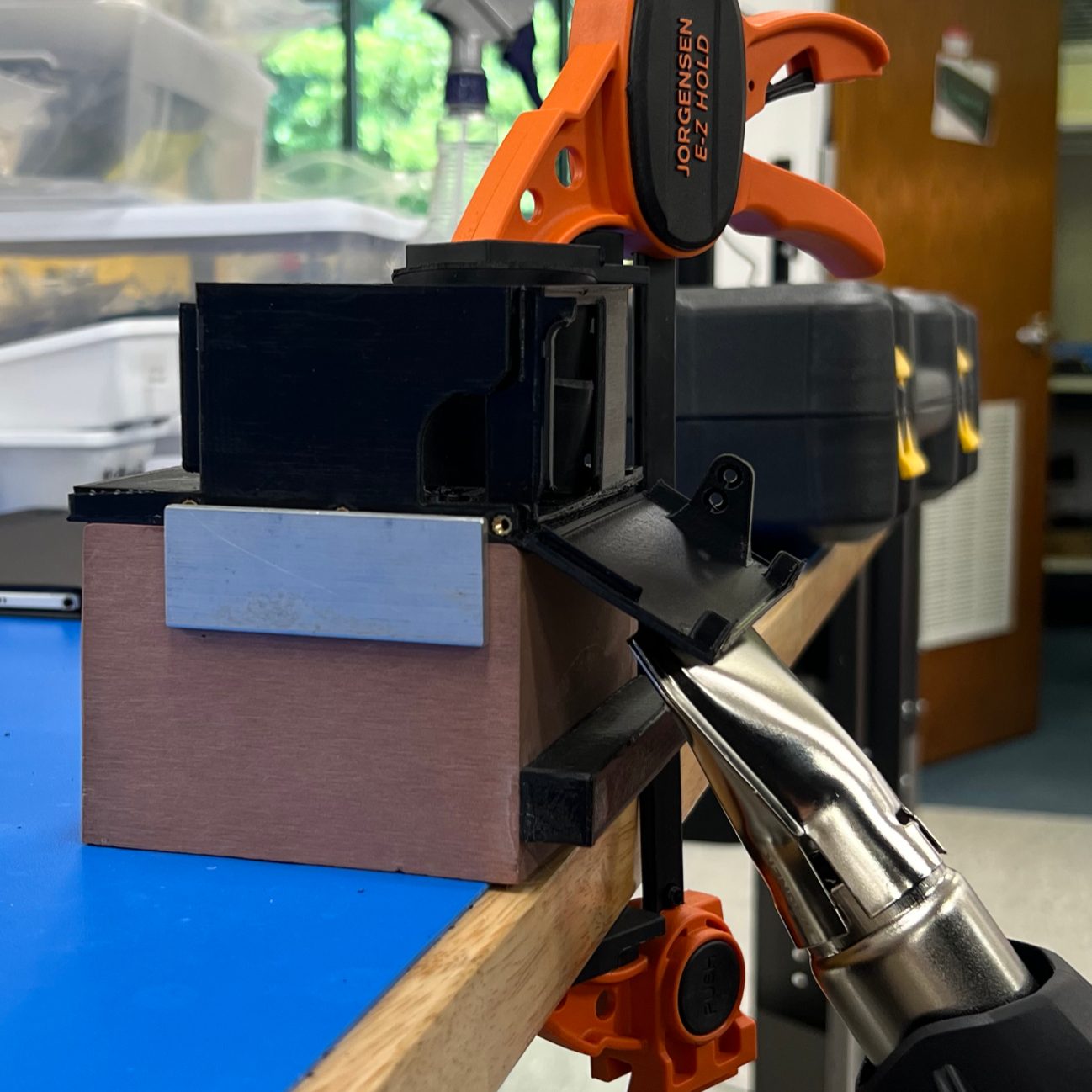 Using a heat gun to fold a 3D printed part to shape.