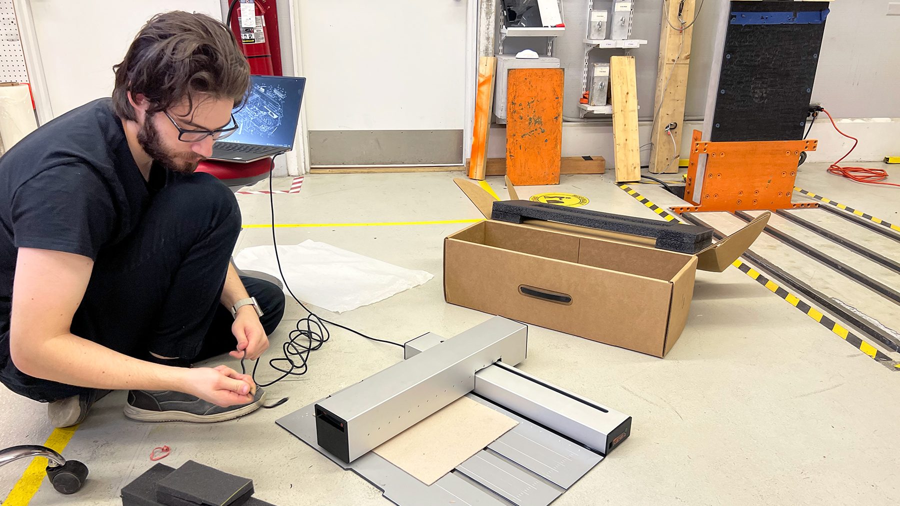 Engineer running an Optic after a drop test to confirm it still works