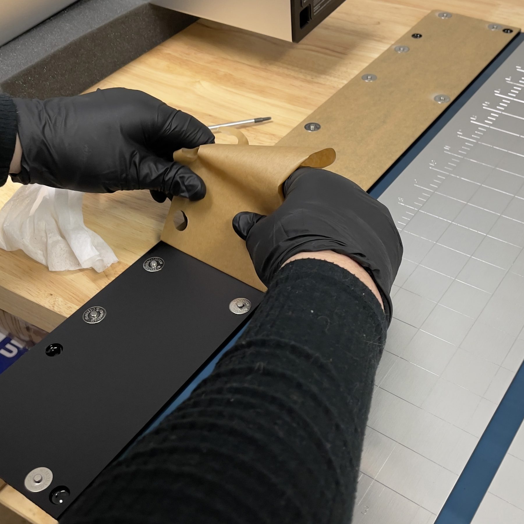 Removing masking from acrylic cutting mat panel.